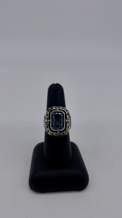 Ss Blue Topaz Scroll Halo